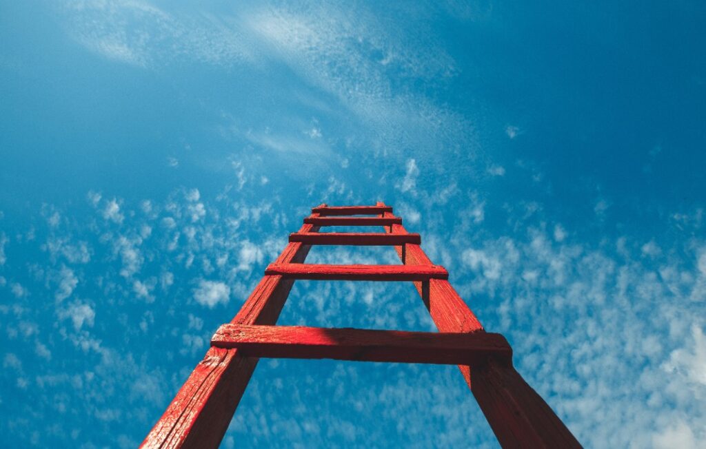 Red ladder against clear blue sky