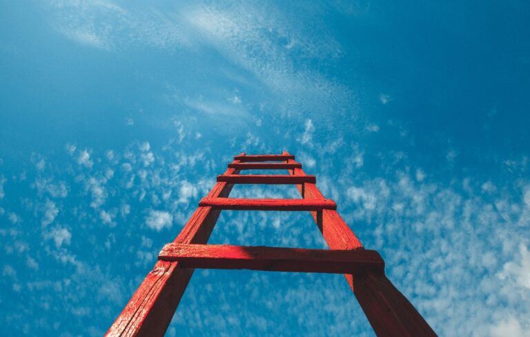Red ladder against clear blue sky